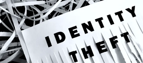 Identity theft A half shredded piece of paper with the words Identity theft on it